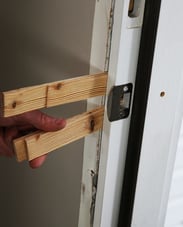 Shims Skinny wooden wedges jammed between a door frame and the jamb.